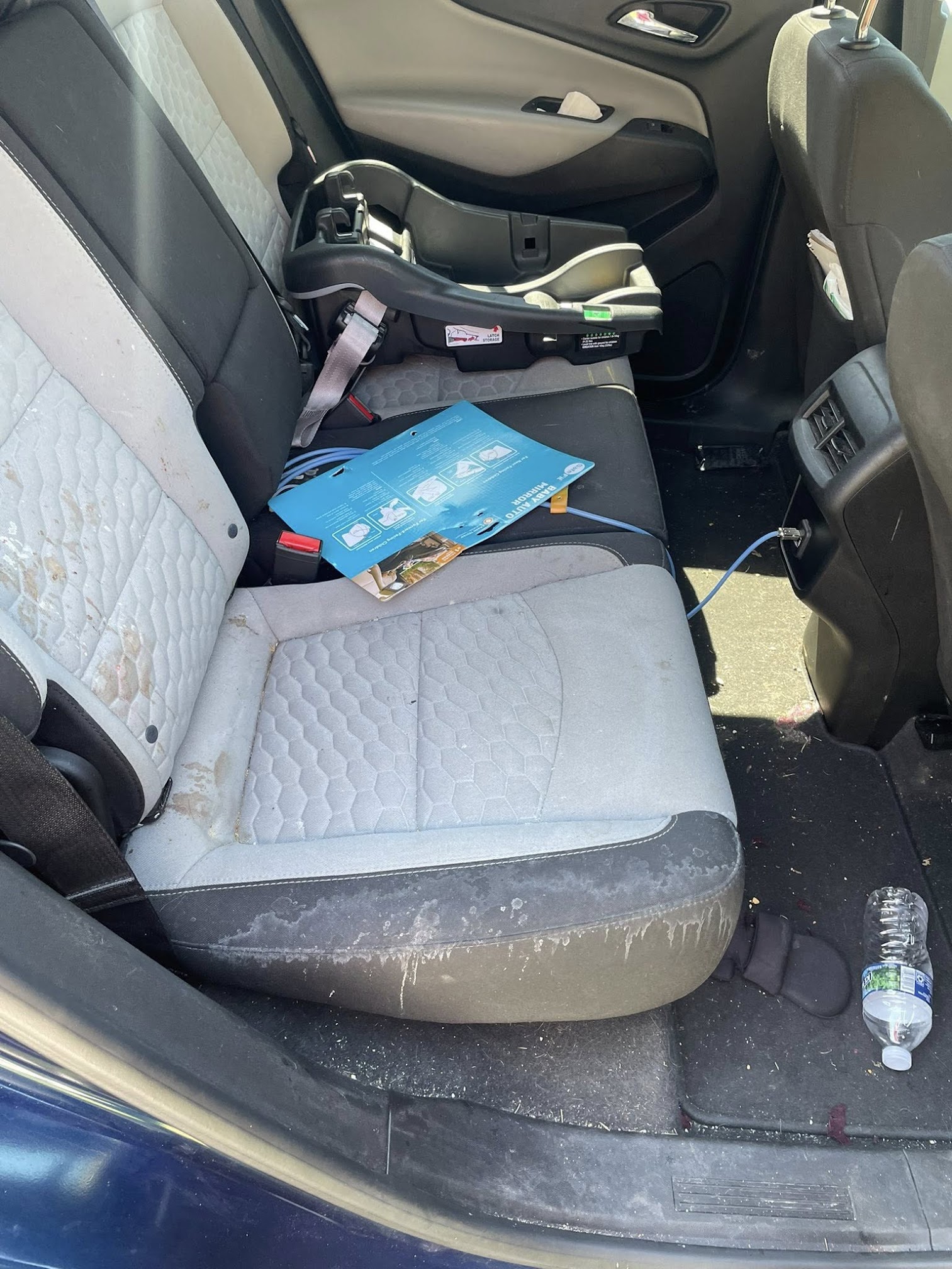Before mobile interior detail showing stained rear seat upholstery and clutter in Danville IL